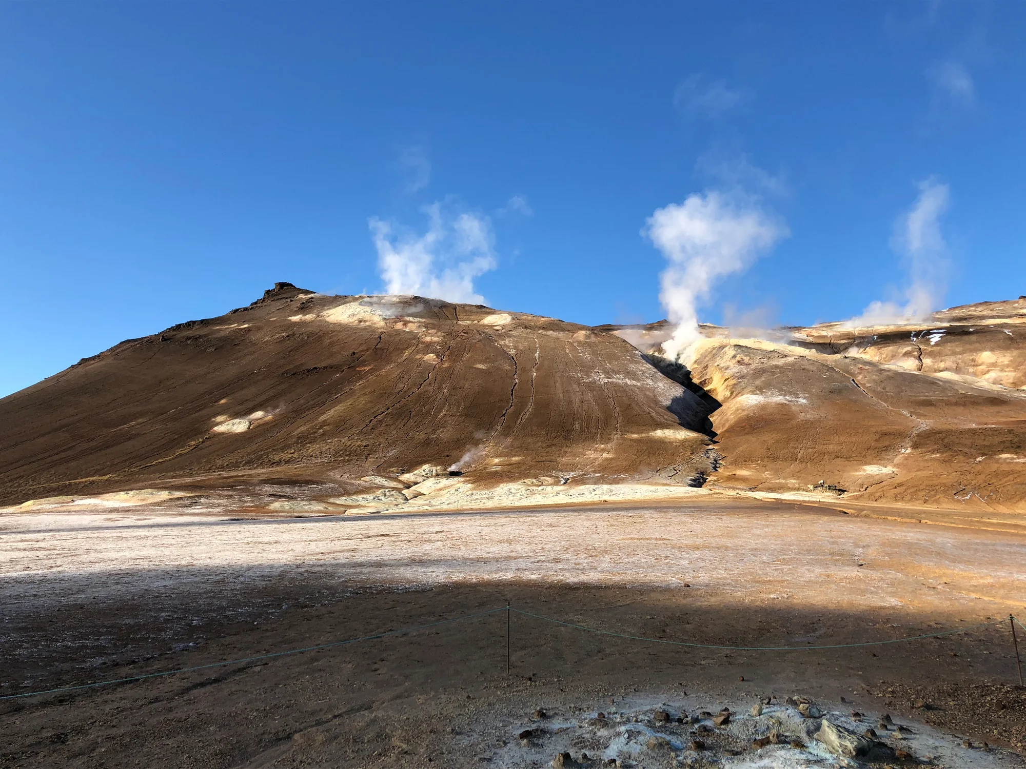 Steam rising above mineral-coloured geothermal hills from Júlli’s Lake Mývatn tour gallery